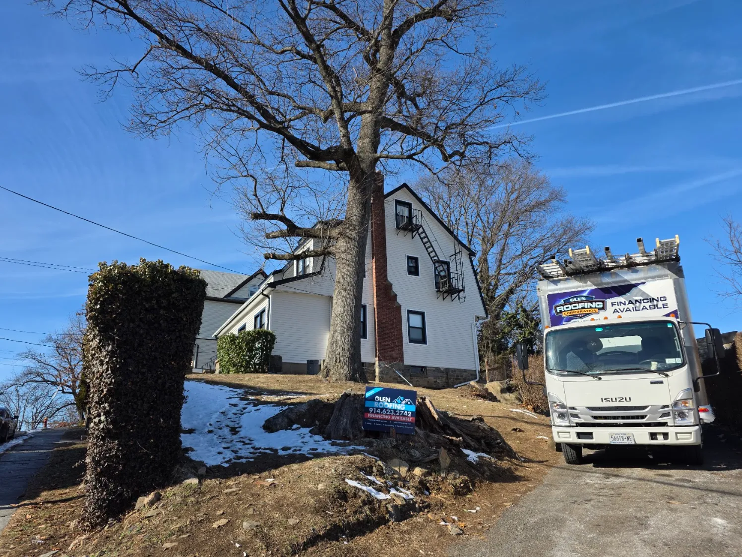 Glen Roofing Corporation truck at a job site
